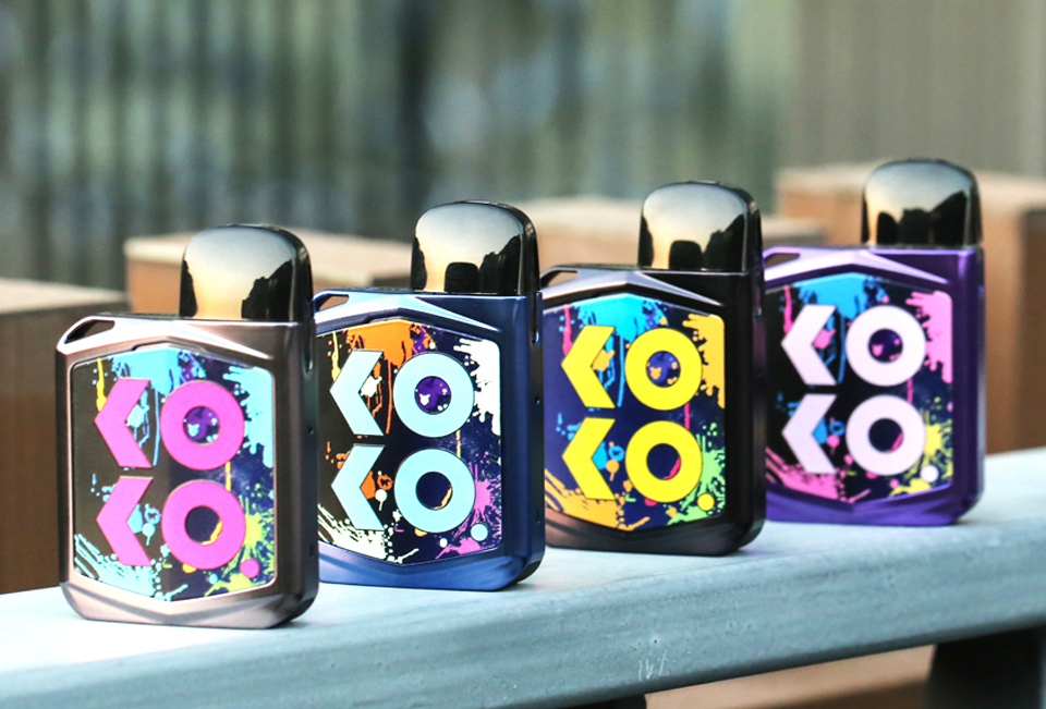 Four KOKO Prime vapes displayed on an outdoor bench,